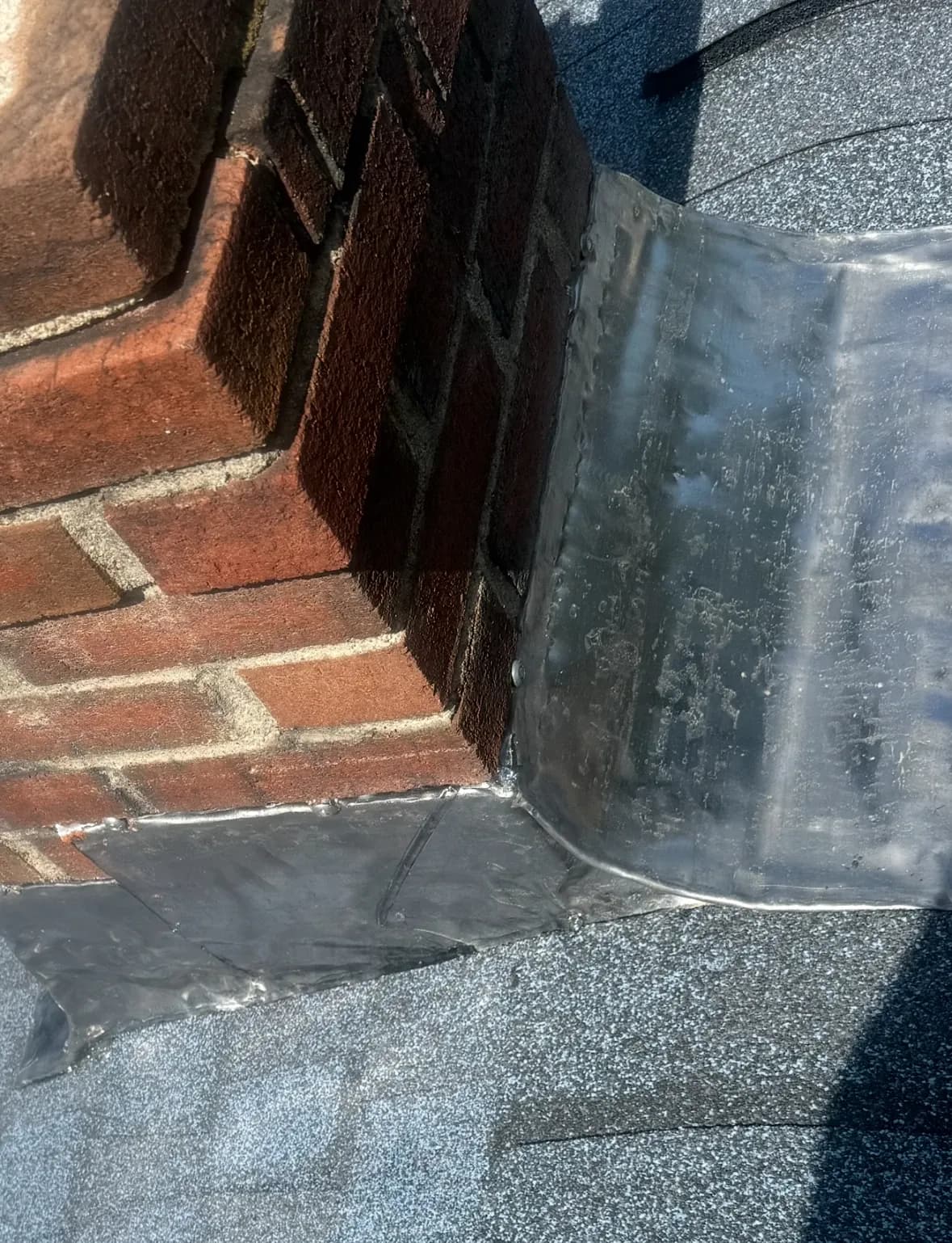 Precision chimney flashing detail demonstrating water-tight installation technique