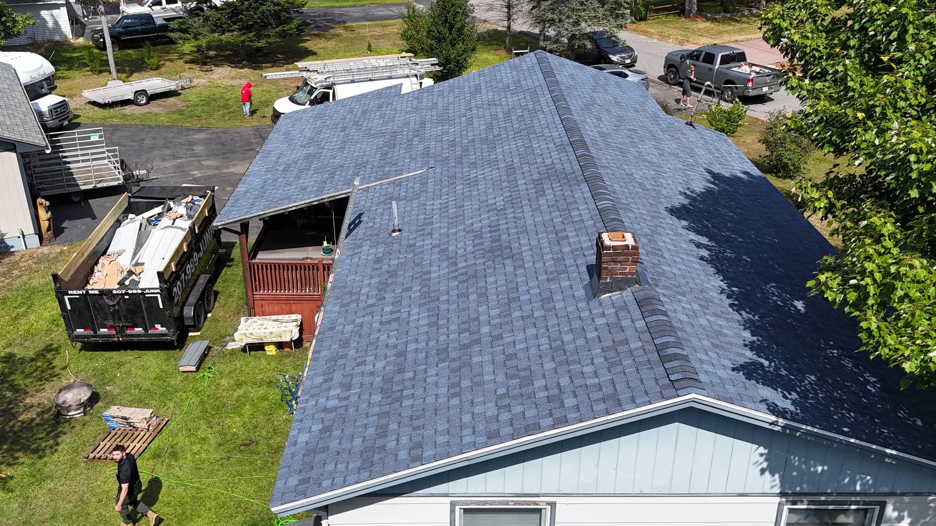 GraniteShield architectural shingle roof replacement aerial view with brick chimney Maine