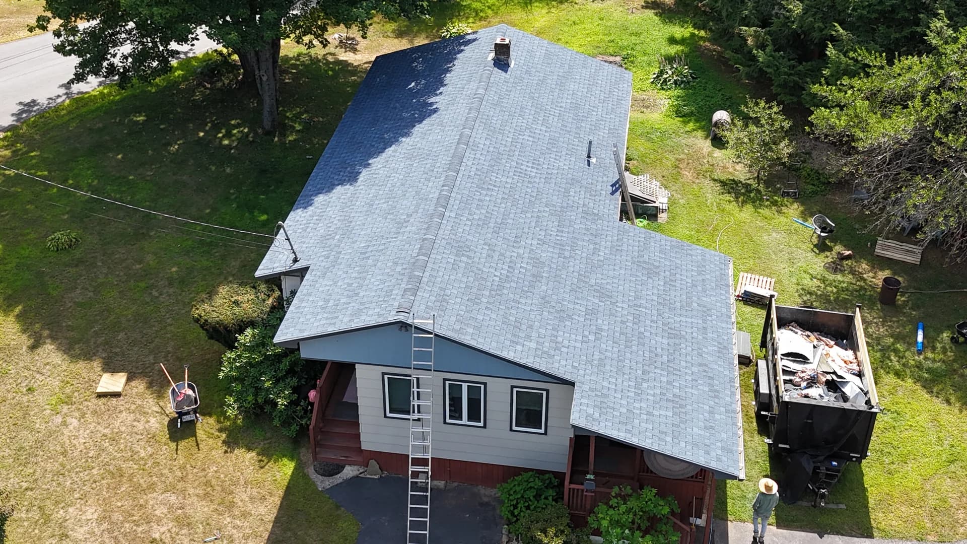 Professional shingle roof installation by GraniteShield Roofing - aerial view of completed gray architectural shingles
